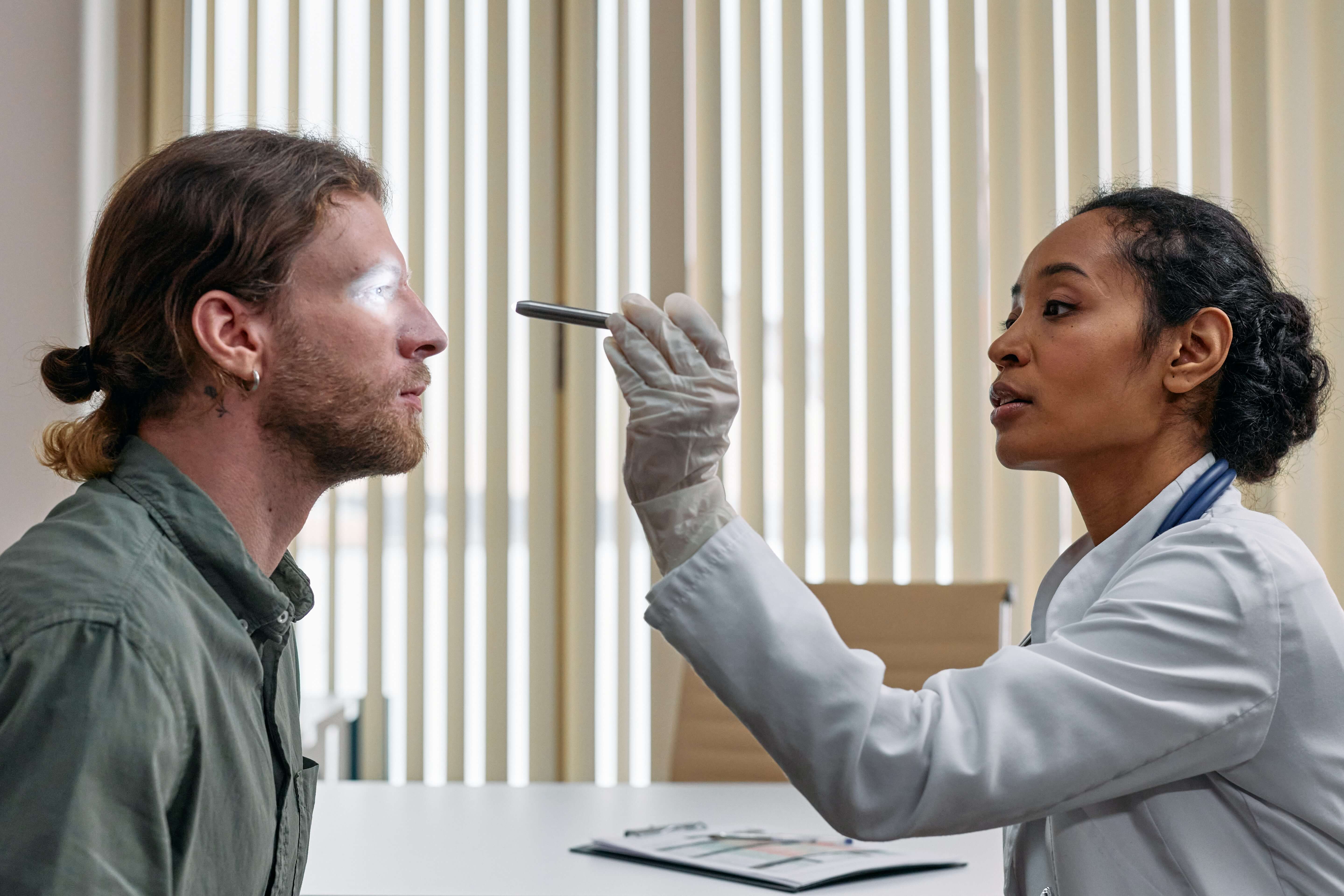 Image of a healthcare provider examining a patient's eyes